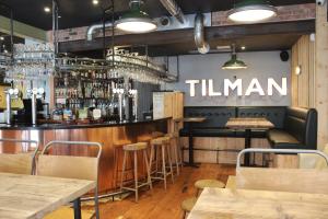 a bar in a restaurant with a sign that reads timman at The Tilman in Barmouth