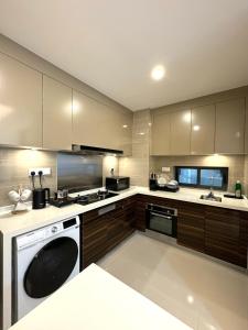 a kitchen with a stove and a dishwasher at R&F Princess Cove Swimming View By TGW STUDIO in Johor Bahru