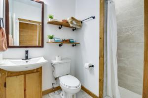 a bathroom with a toilet and a sink and a mirror at 2 Mi to Family Attractions Brownsville Cottage! in Brownsville +16 photos