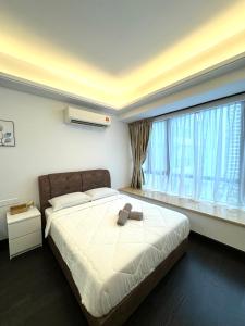 a bedroom with a bed and a large window at R&F Princess Cove Swimming View By TGW STUDIO in Johor Bahru +15 photos