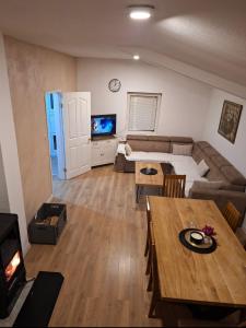 a living room with a couch and a table at Vikendica Ivan Blidinje in Blidinje