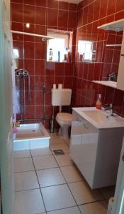 a bathroom with a tub and a toilet and a sink at Vikendica Ivan Blidinje in Blidinje +6 photos