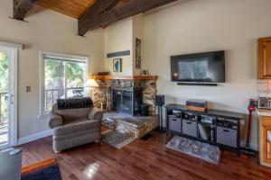 a living room with a fireplace and a television at Dollar Hill II # 25 By Hauserman Rentals in Tahoe City