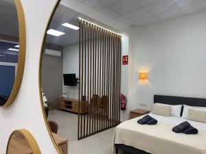 a bedroom with a large bed and a mirror at Basset 3 in Valencia