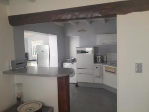a kitchen with white appliances and a counter top at Place Georges Brassens in Cahors