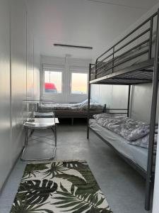a bedroom with two bunk beds and a rug at Fun Like Hel Kite&Wind in Jastarnia