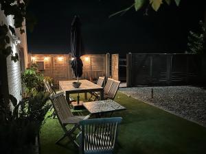 a patio with a table and chairs at night at Asio in Middelkerke