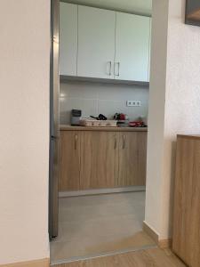 a kitchen with white cabinets and a counter at شقق وفيلا بالبوسنة سراييفو in Blažuj +7 photos