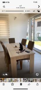 a wooden table with chairs around it in a room at شقق وفيلا بالبوسنة سراييفو in Blažuj