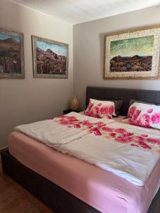 a bedroom with a large bed with pink flowers on it at Azul 41 - Puerto Del Carmen Harbor with Oceanview, pet friendly, Pool in Tías
