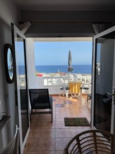 a living room with a view of the ocean at Azul 41 - Puerto Del Carmen Harbor with Oceanview, pet friendly, Pool in Tías +14 photos