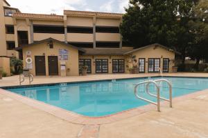 a large swimming pool in front of a building at Historic Santa Maria Inn in Santa Maria