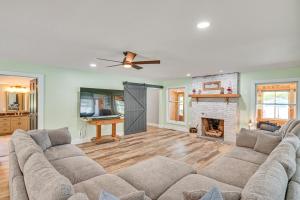 a living room with a couch and a fireplace at Private Indoor Hot Tub Fish and Boat on Sylvan Lake in Rome City