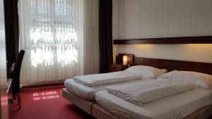 Postel nebo postele na pokoji v ubytování Spalenbrunnen Hotel & Restaurant Basel City Center