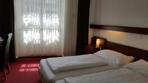 Postel nebo postele na pokoji v ubytování Spalenbrunnen Hotel & Restaurant Basel City Center