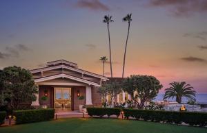 a house with a lawn and palm trees at Montage Laguna Beach in Laguna Beach