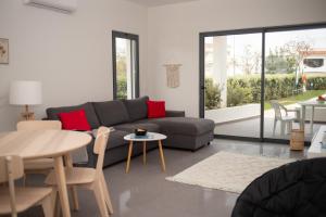 a living room with a couch and a table at Apartament Alvor in Albur Village Lote A in Alvor