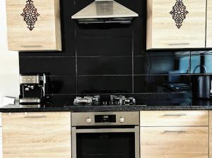a kitchen with a stove and a stove top oven at Villa orangeraie - private pool 35 mn Agadir in Agadir