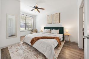 a bedroom with a bed and a ceiling fan at Brightshaven CoolSprings, Modern 1Bed with EV Parking in Frisco in Frisco