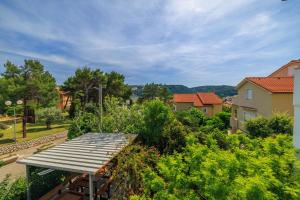 an overhead view of a garden with a wooden deck at Apartments Anica J in Lopar