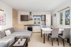 a living room with a couch and a table at Apartment Diana in Povljana +19 photos