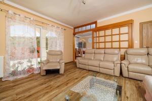 a living room with two couches and two chairs at Apartments Barbara in Supetarska Draga