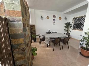 a dining room with a table and chairs at Céntrico adosado cerca de la playa in Punta Umbría