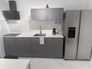 a kitchen with a sink and a refrigerator at Marina Palace duplex in Adeje