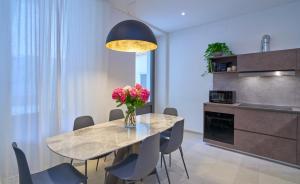 a dining room with a table with flowers on it at Casa Leo in Argegno +16 photos