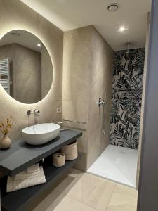 a bathroom with a sink and a mirror at Casa Leo in Argegno +16 photos