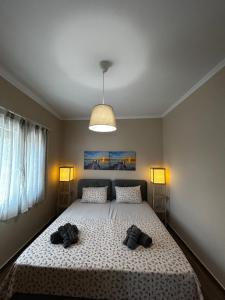 a bedroom with a large bed with two shoes on it at Aithali Home Limnos in Kondopoúlion