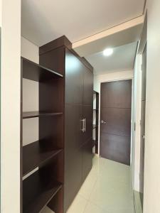 a walk in closet with brown cabinets and a door at Casa Seganis in Bogotá +3 photos