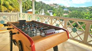 a foosball table on top of a balcony at VILLA La Suite Viva Vero in Les Trois-Îlets