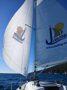 a sail of a boat on the water at Starship JSAILING in Mošćenička Draga