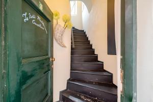 a stairway with a green door and a green stairwell at Romantic room nel Borgo di Cervo in Cervo