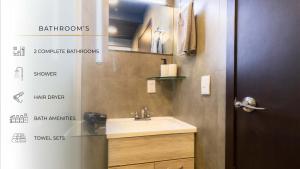 a bathroom with a sink and a door with signs on the wall at 507 Private Terrace 3Bdroom 2Bath AC dwntn CDMX in Mexico City