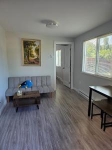 a living room with a couch and a table at Maplewood Hostel in Vancouver