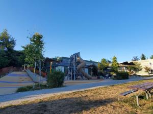 a playground with a slide in a park at Maplewood Hostel in Vancouver