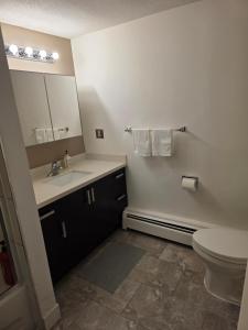 a bathroom with a sink and a toilet and a mirror at Maplewood Hostel in Vancouver +19 photos