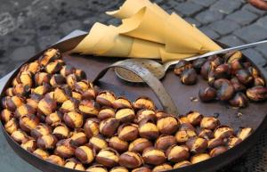 a bunch of chestnuts in a pan on a table at La Casita in Vallerano +10 photos