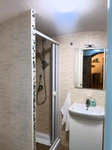 a bathroom with a toilet and a sink and a shower at La Casita in Vallerano