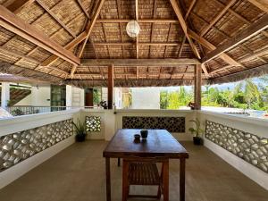 a table in the middle of a room with a ceiling at Alpas Siargao in General Luna