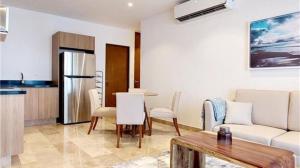 a living room with a couch and a table at Serenada Boutique Condo Near 5th Ave in Playa del Carmen +25 photos