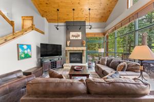 a living room with leather furniture and a fireplace at Ski Tip 8709 by Summit County Mountain Retreats in Keystone