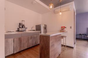 a kitchen with a counter and a refrigerator at Soy Local Parque La 93 in Bogotá +103 photos