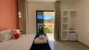a bedroom with a bed with a sliding glass door at Ypê Hospedagem II in Sao Jorge