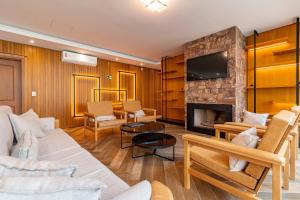 a living room with a couch and a fireplace at Locar-in Canela Bellagio - Infraestrutura Completa in Canela