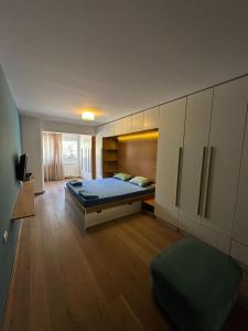 a bedroom with a bed and a tv in it at Venus Luxury Apartment in Skopje