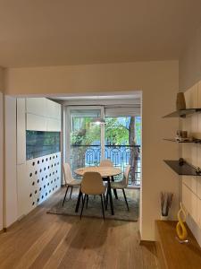 a kitchen and dining room with a table and chairs at Venus Luxury Apartment in Skopje +22 photos