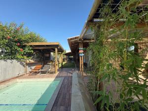 a house with a swimming pool next to a house at Casa de Pedras in Prado